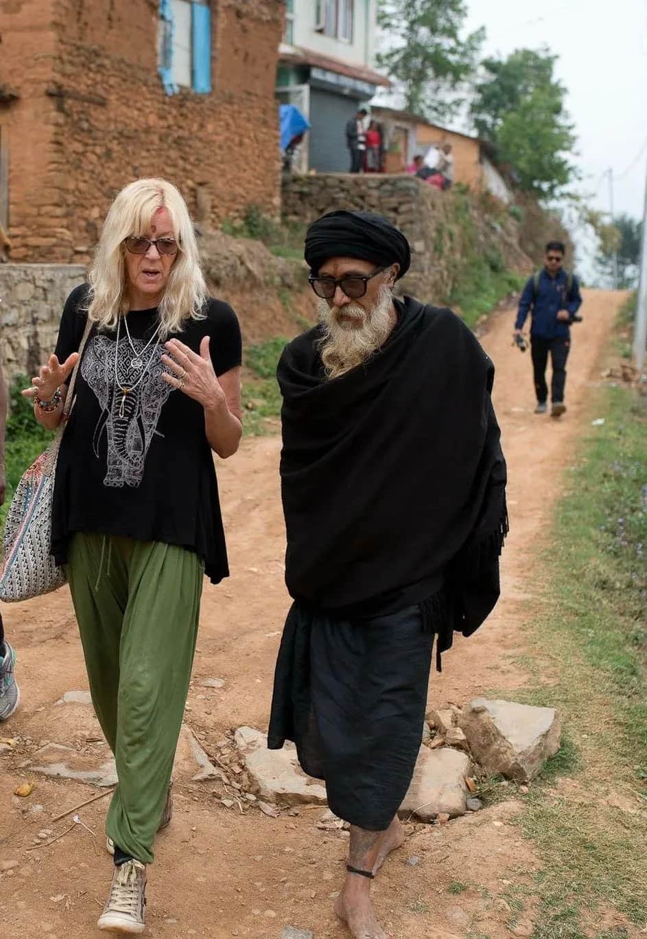 Vivien Row walking alongside a Yogi in India